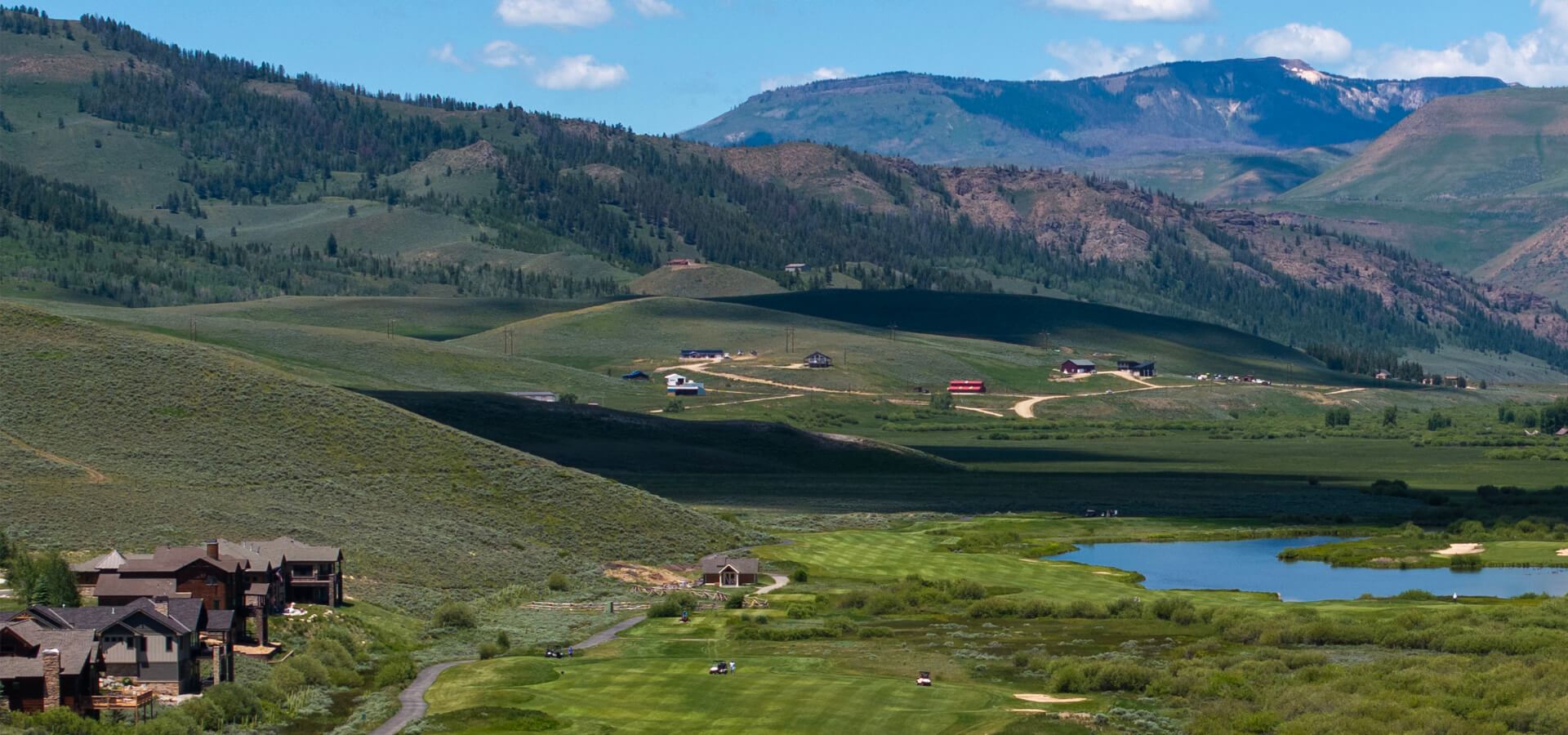 Aerial view of Grand Elk with homes, golf course and mountains in background